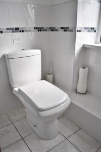 a bathroom with a white toilet in a room at Witchingham B&B in Holyhead