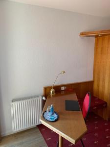 a desk with a lamp and a laptop on it at Hotel Erlenbacher Hof in Bad Homburg vor der Höhe