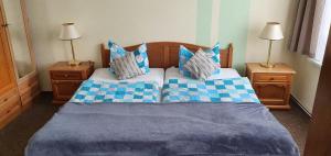 a bedroom with two beds with blue and white pillows at Landgasthof Graf Karstädt in Karstädt +11 photos
