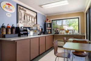 a coffee shop with a counter and a table at Super 8 by Wyndham Gadsden AL in Gadsden