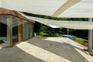 a large building with awning over a patio at A casa do avo Andres in Dumbría