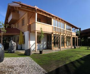 a large building with a grass yard in front of it at Alpinum Junior in Lenggries