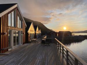a wooden deck with a sunset in the background at Rorbu i Lofoten in Leknes