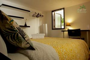 a bedroom with a large bed and a window at Casa The Garden Las Palmas in Las Palmas de Gran Canaria