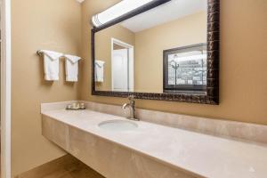a bathroom with a sink and a mirror at La Quinta by Wyndham Seattle Downtown in Seattle