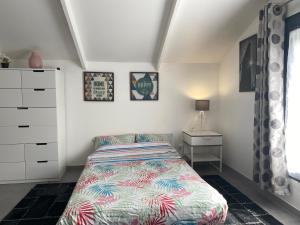 a small bedroom with a bed and a dresser at Trendy studios Tassin in Tassin-la-Demi-Lune