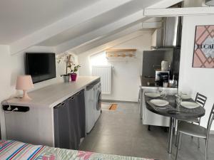 a kitchen with a table and a dining room at Trendy studios Tassin in Tassin-la-Demi-Lune