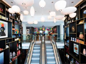 a shopping mall with escalators and lights at citizenM Paris La Défense in Nanterre