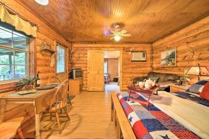 Cozy Davis Cabin with Deck - Nestled by Honey Creek! في Davis: كابينة جلوس خشبية مع أريكة وطاولة