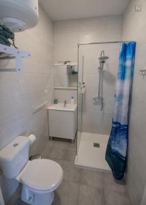 a bathroom with a shower and a toilet and a sink at Casa Playa Ondina in Gáldar