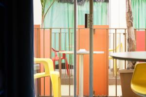 a room with chairs and tables and a fence at Banana Bungalow West Hollywood Hotel & Hostel in Los Angeles
