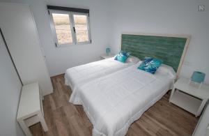 En eller flere senge i et værelse på Casa Playa Ondina