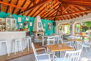 a restaurant with wooden ceilings and tables and chairs at Sergios in Koukounaries