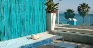 a hat sitting on a table next to a pool at H Boutique Peña Parda in La Herradura