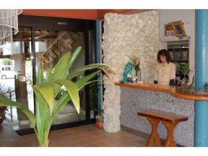 a woman standing at a counter in a restaurant at Amami Resort Bashayamamura / Vacation STAY 81479 in Amami