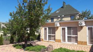 a house with a tree in front of it at Villa Lina in Karolino-Buhaz +20 photos