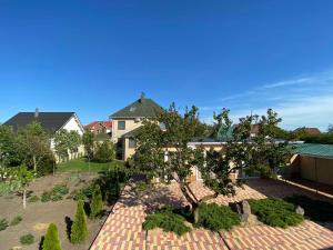 a house with a tree in a garden at Villa Lina in Karolino-Buhaz