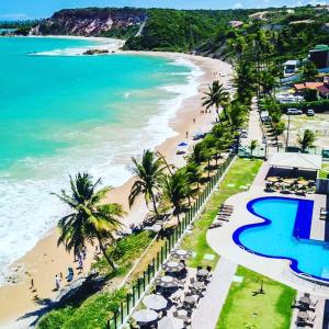 an aerial view of a beach with palm trees and the ocean at Tabatinga Residence Service - Flat 02 in Conde