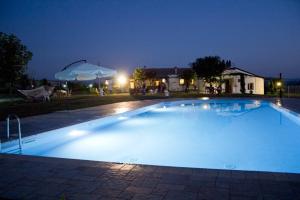 a large swimming pool at night at Villa Lancellotti in Irsina