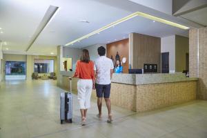 a man and a woman standing in front of a counter at Alta Vista Thermas Resort in Caldas Novas +37 photos