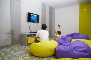 a man and a child sitting on a bean bag at Alta Vista Thermas Resort in Caldas Novas