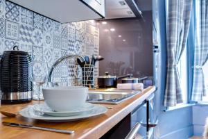 a kitchen with a sink and a bowl on a counter at SixtySix by Sorted Stay in Southend-on-Sea