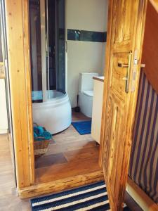 a bathroom with a toilet and a wooden door at Chata Morgana in Bolków