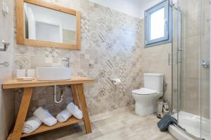 a bathroom with a toilet and a sink and a shower at ANEMOLIA in Agios Ioannis Kaspaka