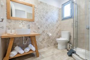 a bathroom with a toilet and a sink and a shower at ANEMOLIA in Agios Ioannis Kaspaka +23 photos