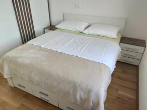 - une chambre avec un lit doté de draps et d'oreillers blancs dans l'établissement Panoramic view apartments Crikvenica, à Crikvenica