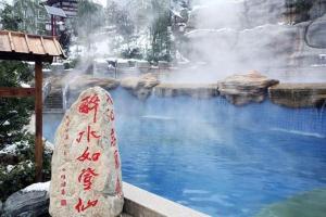 a pool of water with a waterfall in a zoo at 7Days Premium Xi'an Lantian Lanxin Road Branch in Xi'an