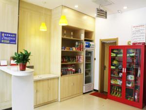 a kitchen with a refrigerator and a red door at 7Days Premium Xi'an Lantian Lanxin Road Branch in Xi'an