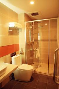 a bathroom with a toilet and a glass shower at 7Days Premium Zhangjiakou Huailai County Shacheng Branch in Huailai +28 photos