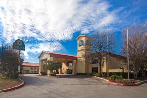 a building with a clock tower in a parking lot at La Quinta Inn by Wyndham San Marcos in San Marcos