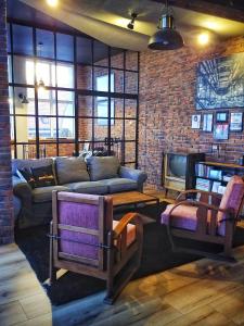 a living room with a couch and a brick wall at LOFT 57 CENTRUM in Olsztyn