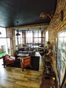 a living room with a couch and a brick wall at LOFT 57 CENTRUM in Olsztyn