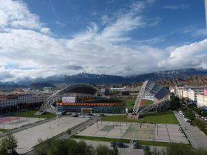 a view of a stadium with mountains in the background at 7Days Premium Delingha Center Plaza Branch in Delingha