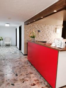 a red counter in a room with a stone floor at Hotel zur Post in Arnsberg