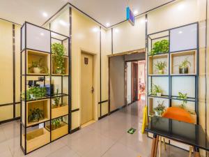 a room filled with plants on shelves at 7Days Premium Beijing Happy Valley Wangsiyingqiao Branch in Beijing