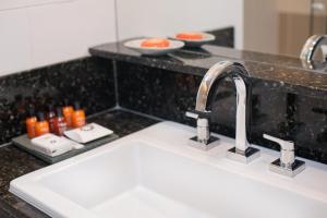a kitchen counter top with a sink and a sink at Sol Ipanema Hotel in Rio de Janeiro