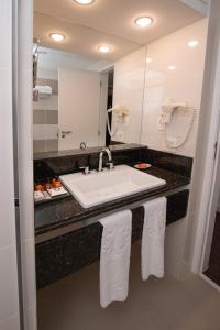 
a bathroom with a sink and a towel rack at Sol Ipanema Hotel in Rio de Janeiro
