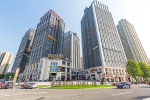 a city with tall buildings and a street with cars at 7Days Premium Chongqing Jiangbei International Airport Lushan Light Rail Station Branch in Chongqing