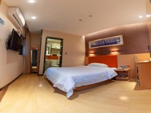 a bedroom with a large bed and a television at 7Days Premium Nanchong Silk Road Branch in Nanchong