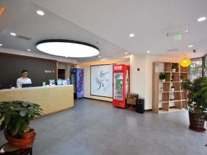 a store lobby with a cash register and a person in a store at 7Days Premium Qingdao Technology Street Branch in Qingdao