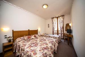 Postel nebo postele na pokoji v ubytování Hotel Ristorante Farneta