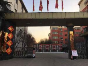 a bridge with flags on top of it with buildings at 7Days Premium Xingtai Zhongxing West Street Gushun Branch in Xingtai