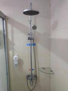 a shower with a glass shelf in a bathroom at 7Days Premium Suzhou Tongli Ancient Town Branch in Suzhou