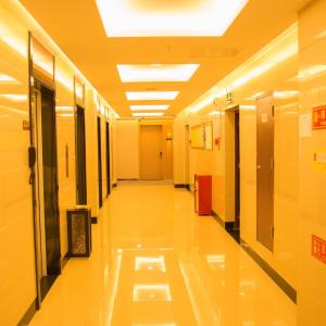 an empty hallway in a hospital with lights on the ceiling at 7Days Premium Chongqing Nanchuan Government Square Branch in Nanchuan