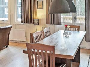 a dining room with a large table and chairs at 10 person holiday home in S LEN in Sälen