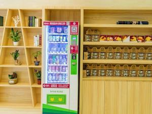 a vending machine in a store with drinks in it at 7Days Premium Xiamen Airport Xianglu Branch in Xiamen